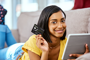 Teenager holding up first credit card